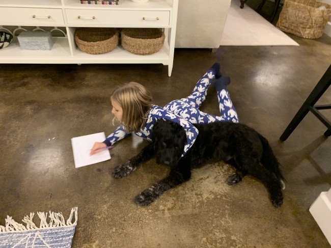Katie reading with her best friend, Chase.