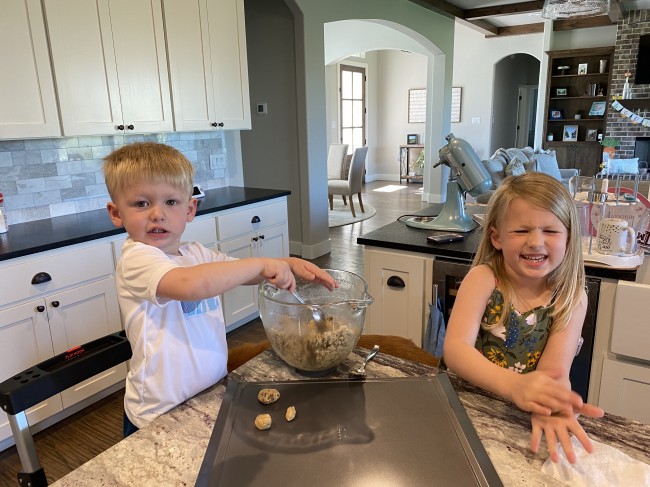 The kids helped roll up the dough into balls and place them on the sheet for baking The kids helped roll up the dough into balls and place them on the sheet for baking