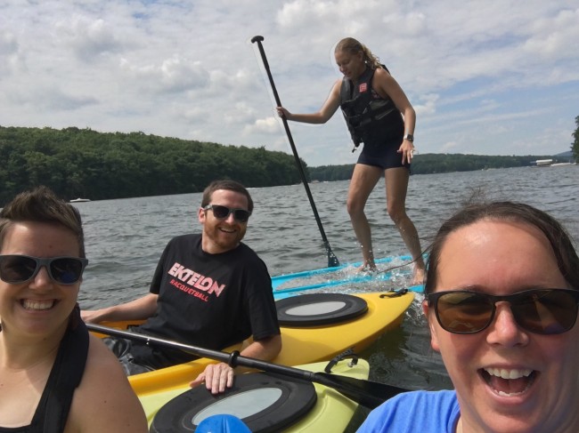 Amy attempting to paddleboard for the first time.