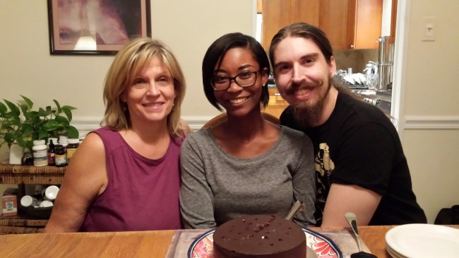 Amy's Mom, Brother and sister in law posing for a pic at a birthday dinner.