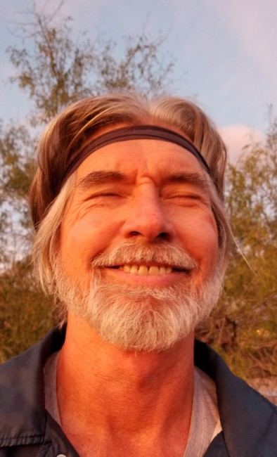 Amy's dad smiling big during a beautiful evening hike.