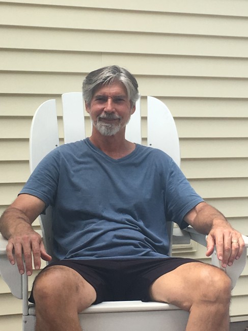 Amy's Dad smiling on the deck during a Father's Day cookout.
