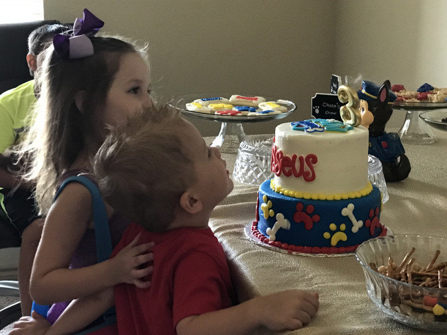 Our niece Scoutlynn helping her brother, Kasseus, get a good look at his cake!