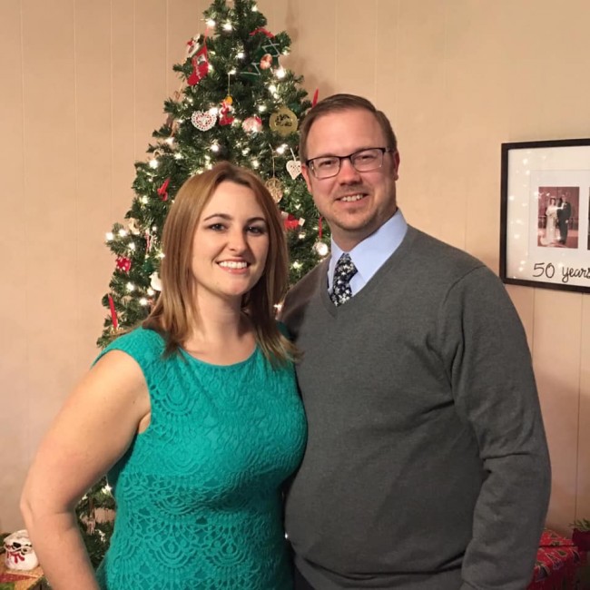 In front of the tree at David's parents' house in 2018.