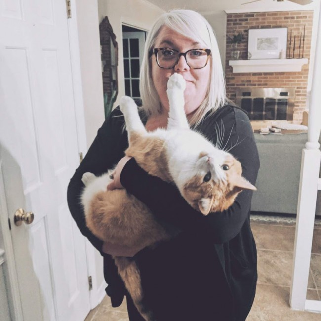 Charlie may weigh 18 pounds, but Alex doesn't care. She's carried him like this since he was a kitten.