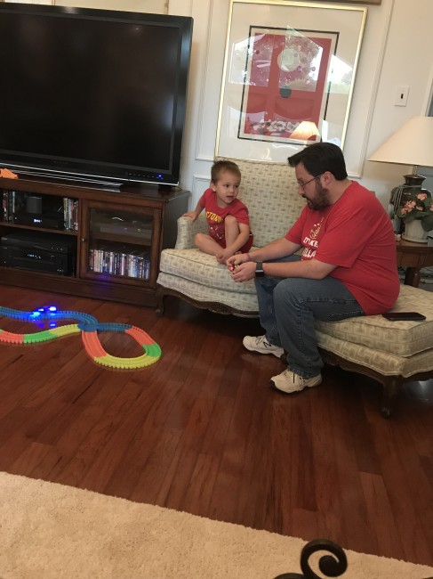 Wyatt showing our young nephew how to use his new race track