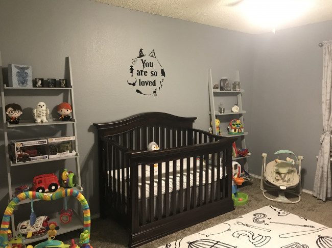 A larger view of the crib and bookshelves as we are adding decor. We love the decal above the bed-one of our favorite quotes from the book but also how we feel. Our son or daughter will always know that they are loved.