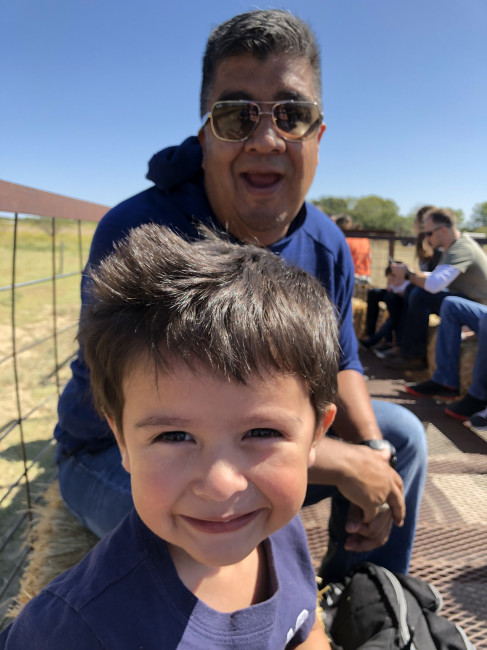 Jeff and Conner on a hayride. Hold on!