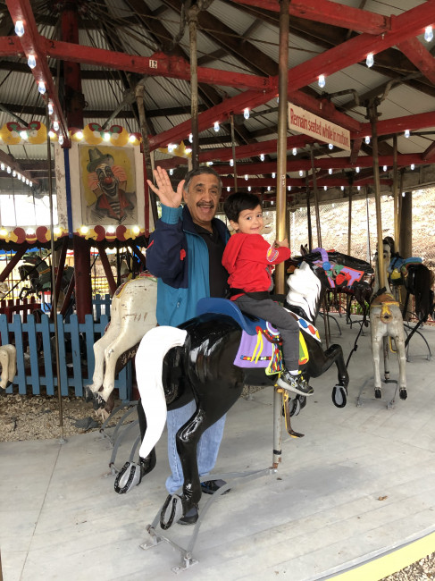 Conner and Popo riding the carousel.