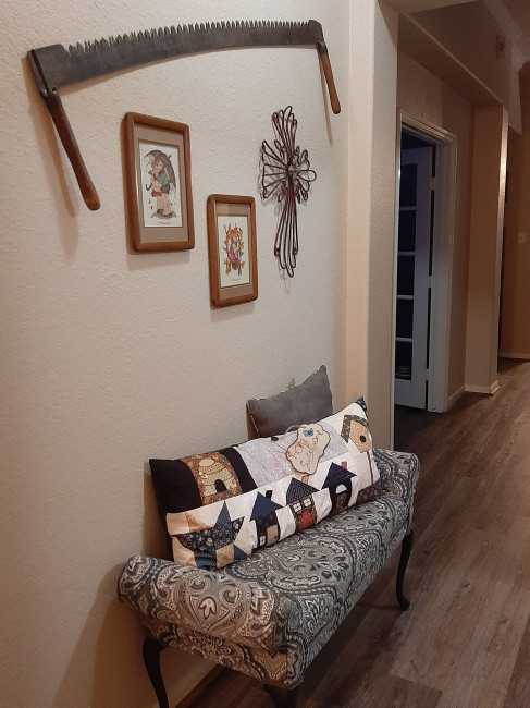 We reupholstered this bench together, and the items on the wall are family heirlooms.