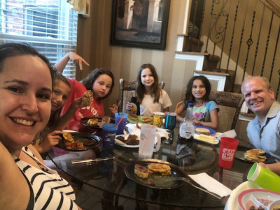 We always eat dinner together at the dinner table and no one can eat until we all hold hands and say grace. We especially love having friends over for dinner, too.