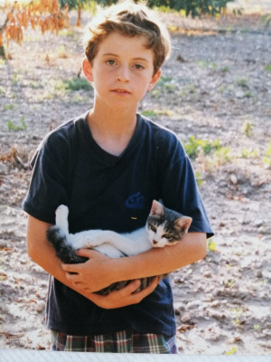 We love animals. Here is Marc holding a cat when he was a kid.